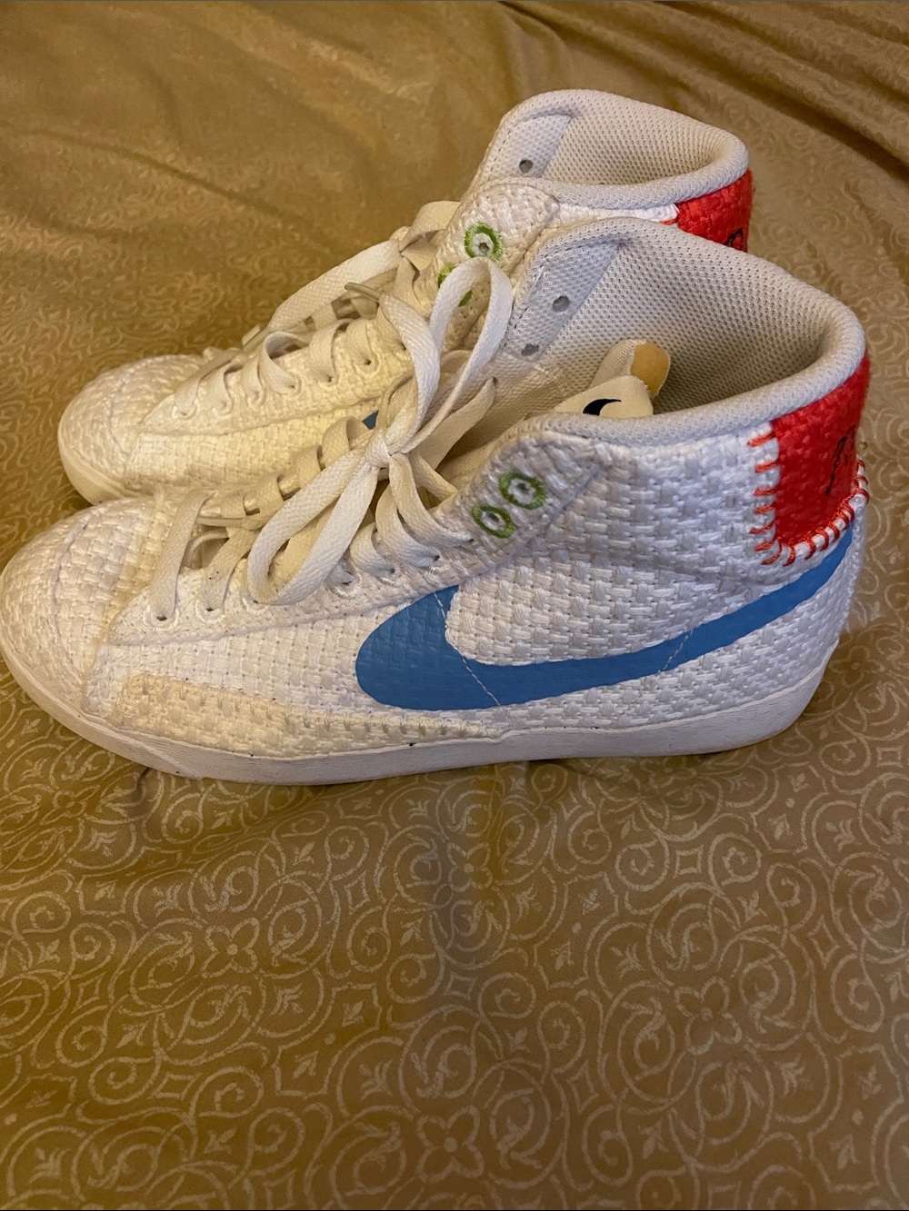 Nike White High-Top Sneakers with Blue Swoosh and Red Heel Stitching